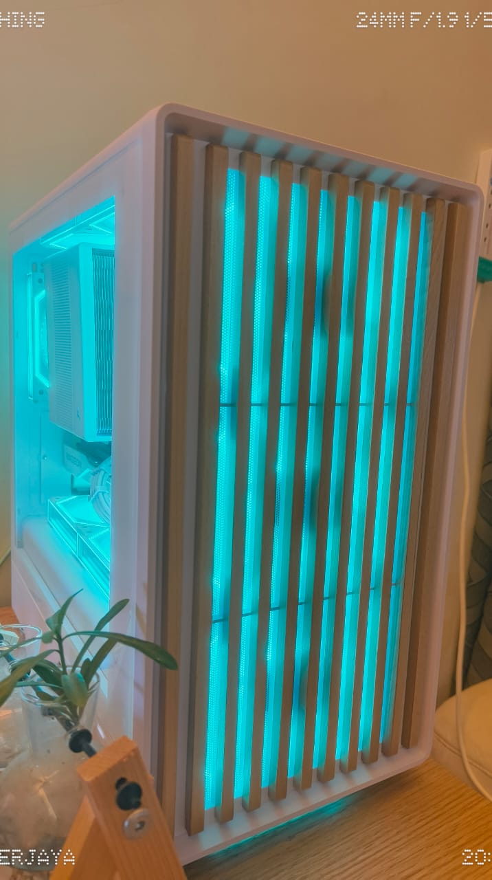 Custom PC with slatted front panel lit from behind with teal RGB
